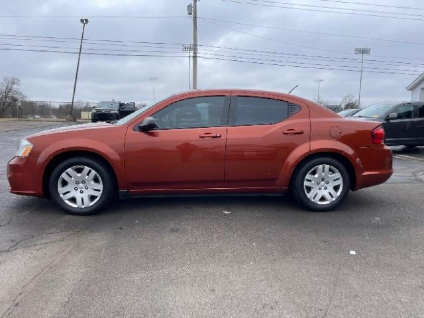 2012 Orange Dodge Avenger Base (1C3CDZAB1CN) with an 2.4L L4 DOHC 16V engine, 4-Speed Automatic transmission, located at 880 E. National Road, Vandalia, OH, 45377, (937) 908-9800, 39.892189, -84.181015 - Photo#2