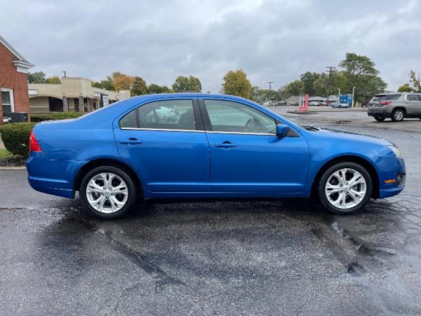 2012 Blue Flame Metallic Ford Fusion SE (3FAHP0HG6CR) with an 3.0L V6 DOHC 24V engine, located at 401 Woodman Dr, Riverside, OH, 45431, (937) 908-9800, 39.763779, -84.122063 - Photo#4