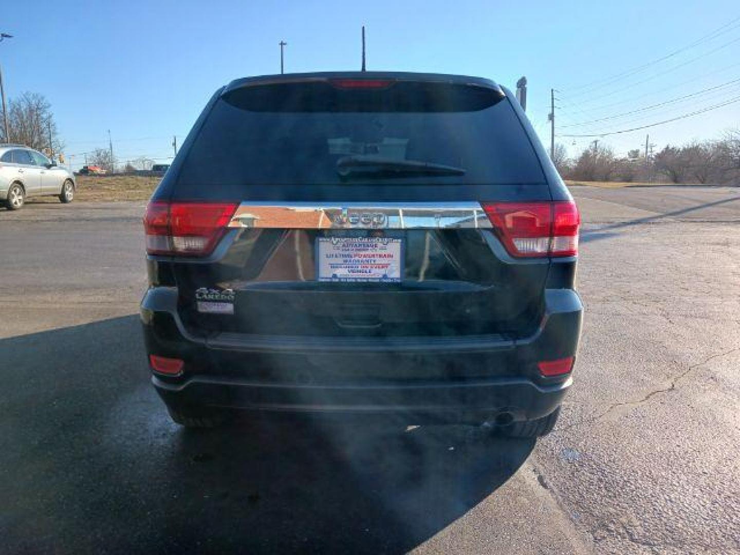 2012 Brilliant Black Crystal Pearl Jeep Grand Cherokee Laredo 4WD (1C4RJFAG1CC) with an 3.6L V6 DOHC 24V engine, 5-Speed Automatic transmission, located at 1184 Kauffman Ave, Fairborn, OH, 45324, (937) 908-9800, 39.807365, -84.029114 - Photo#5