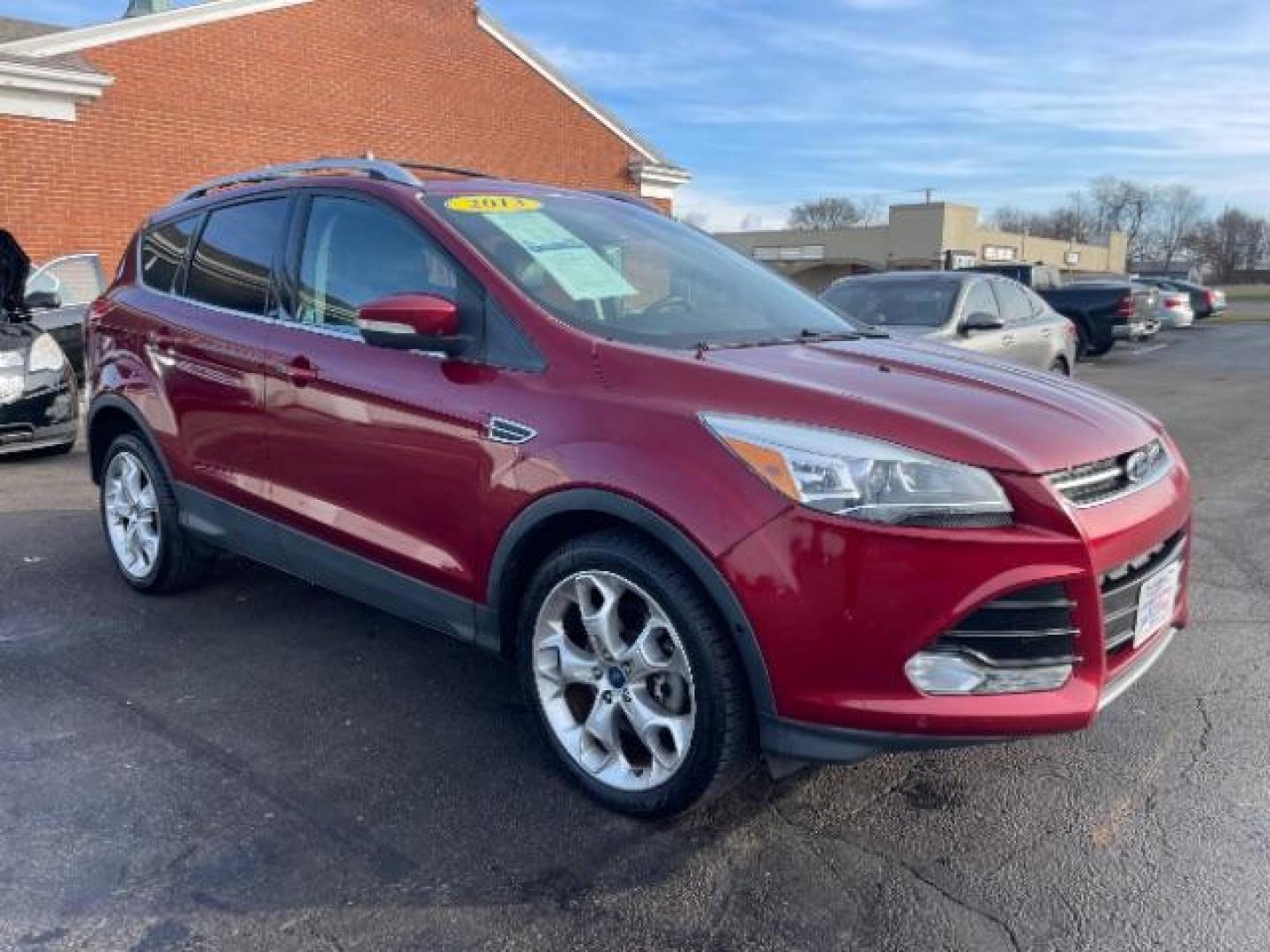 2013 Ruby Red Metallic Tinted Ford Escape Titanium 4WD (1FMCU9J92DU) with an 2.0L L4 DOHC 16V engine, 6-Speed Automatic transmission, located at 4508 South Dixie Dr, Moraine, OH, 45439, (937) 908-9800, 39.690136, -84.216438 - Photo#0