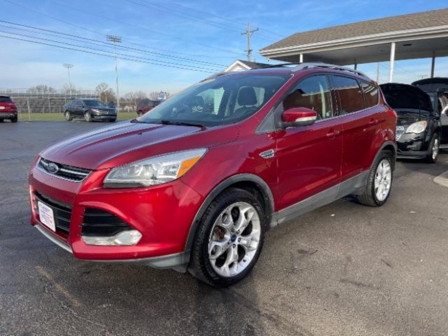 2013 Ruby Red Metallic Tinted Ford Escape Titanium 4WD (1FMCU9J92DU) with an 2.0L L4 DOHC 16V engine, 6-Speed Automatic transmission, located at 4508 South Dixie Dr, Moraine, OH, 45439, (937) 908-9800, 39.690136, -84.216438 - Photo#1