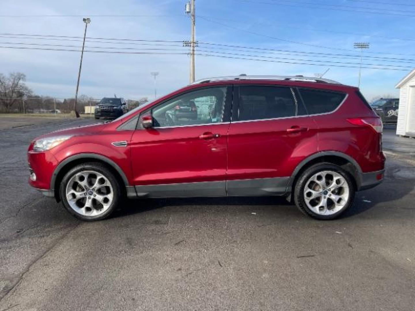 2013 Ruby Red Metallic Tinted Ford Escape Titanium 4WD (1FMCU9J92DU) with an 2.0L L4 DOHC 16V engine, 6-Speed Automatic transmission, located at 4508 South Dixie Dr, Moraine, OH, 45439, (937) 908-9800, 39.690136, -84.216438 - Photo#4