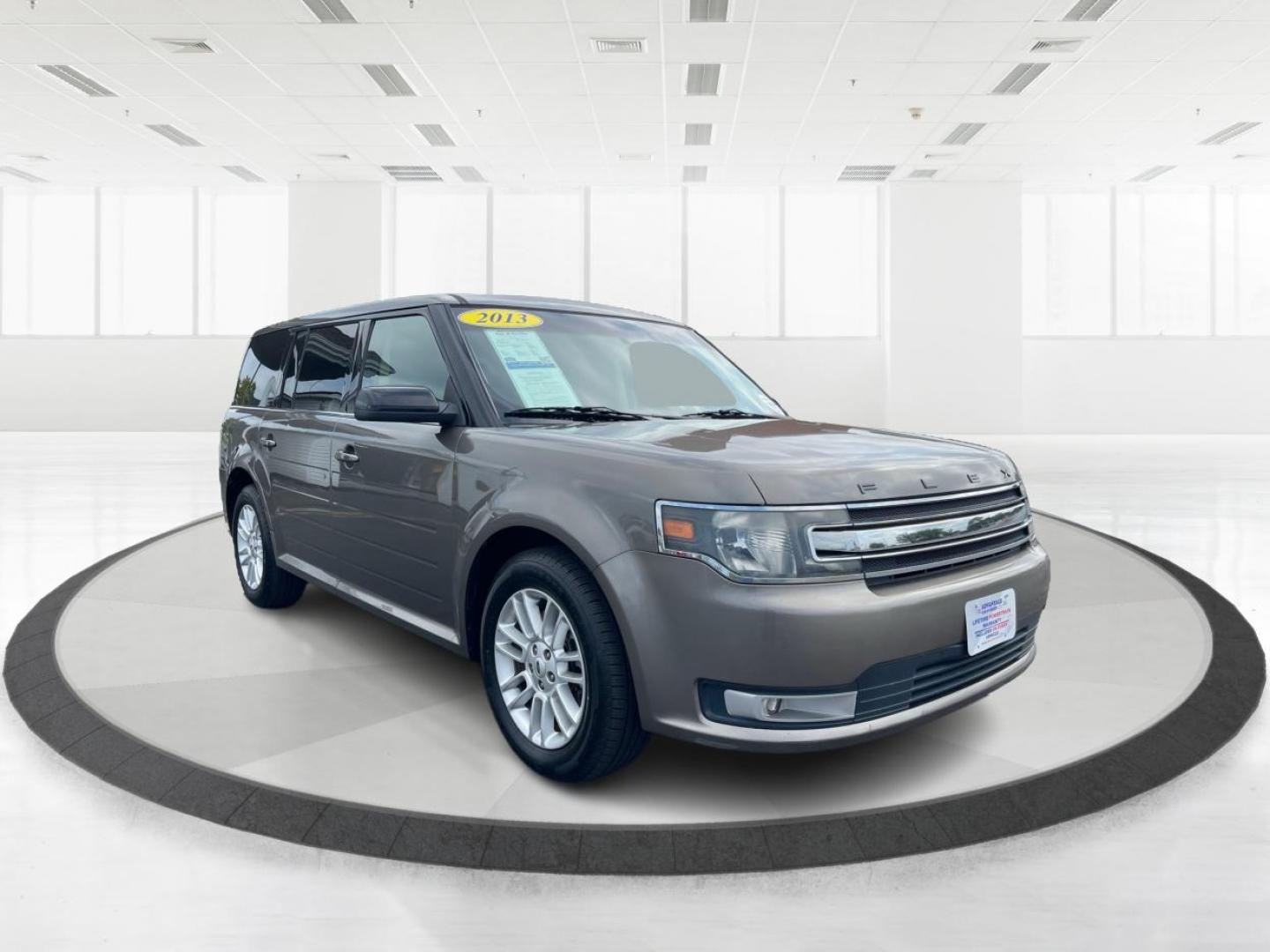 2013 Mineral Gray Metallic Ford Flex SEL FWD (2FMGK5C85DB) with an 3.5L V6 DOHC 24V engine, 6-Speed Automatic Overdrive transmission, located at 880 E. National Road, Vandalia, OH, 45377, (937) 908-9800, 39.892189, -84.181015 - Third Row - Photo#0