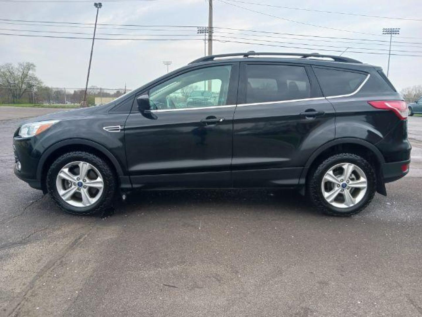 2014 Tuxedo Black Ford Escape SE 4WD (1FMCU9G99EU) with an 2.0L L4 DOHC 16V engine, 6-Speed Automatic transmission, located at 880 E. National Road, Vandalia, OH, 45377, (937) 908-9800, 39.892189, -84.181015 - Photo#3