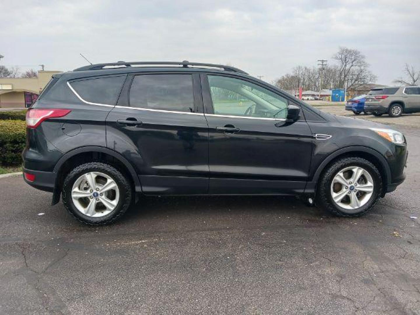 2014 Tuxedo Black Ford Escape SE 4WD (1FMCU9G99EU) with an 2.0L L4 DOHC 16V engine, 6-Speed Automatic transmission, located at 880 E. National Road, Vandalia, OH, 45377, (937) 908-9800, 39.892189, -84.181015 - Photo#4