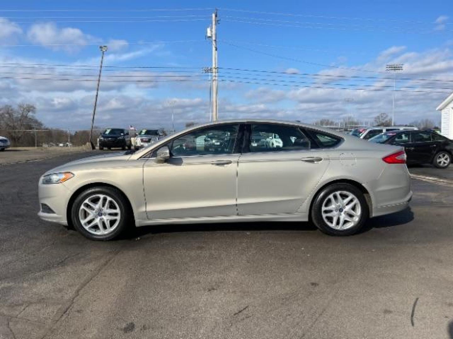 2016 Brown Ford Fusion SE (3FA6P0H70GR) with an 2.5L L4 DOHC 16V engine, 6-Speed Automatic transmission, located at 1951 S Dayton Lakeview Rd., New Carlisle, OH, 45344, (937) 908-9800, 39.890999, -84.050255 - Photo#2