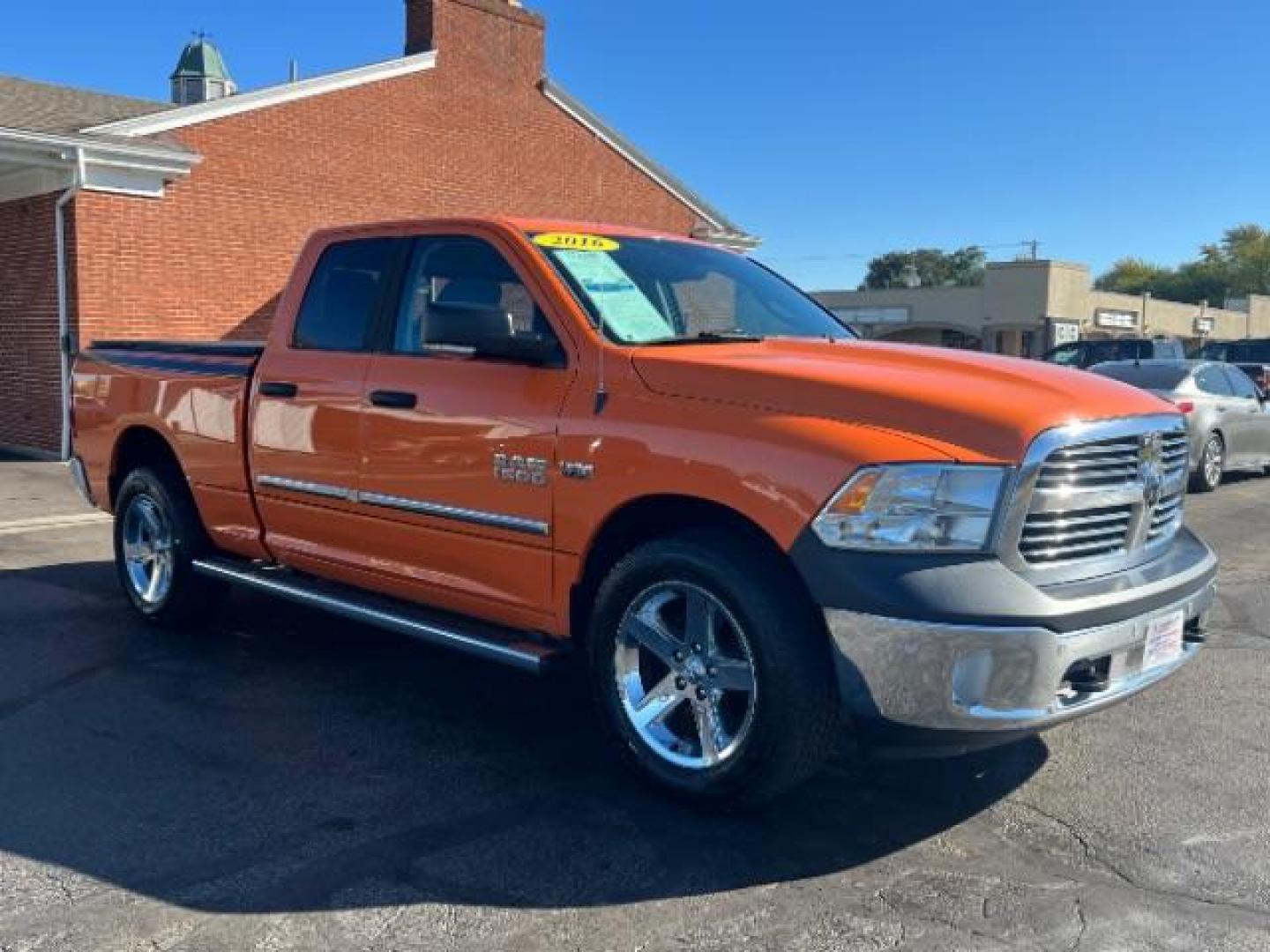 2016 Low Vol Omaha Orange RAM 1500 SLT Quad Cab 4WD (1C6RR7GT3GS) with an 5.7L V8 OHV 16V engine, 8-Speed Automatic transmission, located at 1184 Kauffman Ave, Fairborn, OH, 45324, (937) 908-9800, 39.807365, -84.029114 - Photo#0