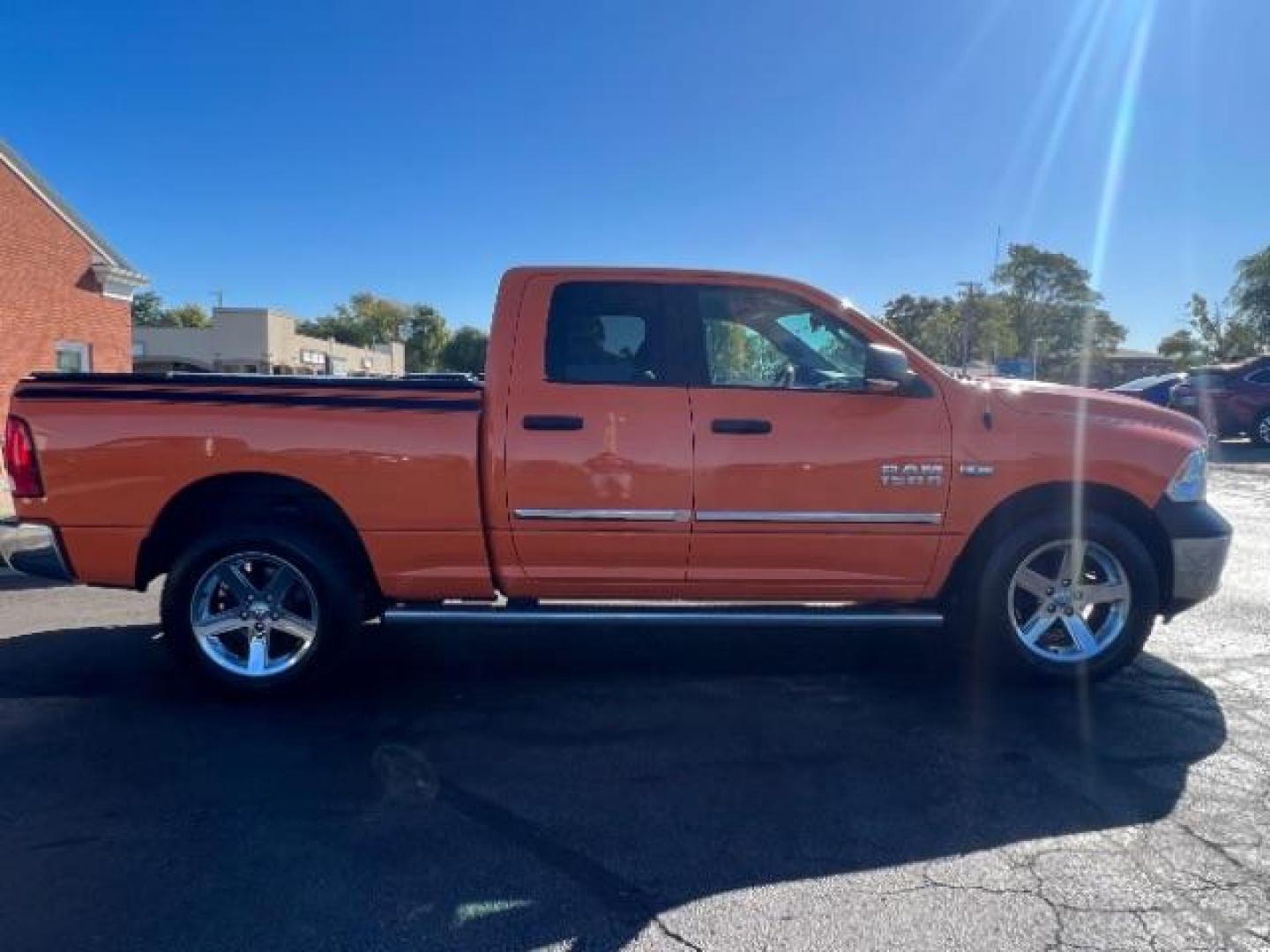 2016 Low Vol Omaha Orange RAM 1500 SLT Quad Cab 4WD (1C6RR7GT3GS) with an 5.7L V8 OHV 16V engine, 8-Speed Automatic transmission, located at 1184 Kauffman Ave, Fairborn, OH, 45324, (937) 908-9800, 39.807365, -84.029114 - Photo#5