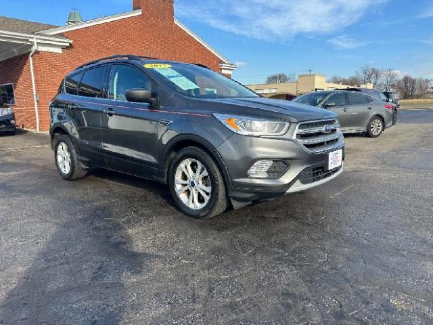 2017 Magnetic Metallic Ford Escape SE 4WD (1FMCU9G91HU) with an 2.0L L4 DOHC 16V engine, 6-Speed Automatic transmission, located at 1099 N County Rd 25A, OH, 45373, (937) 908-9800, 40.057079, -84.212883 - Photo#0